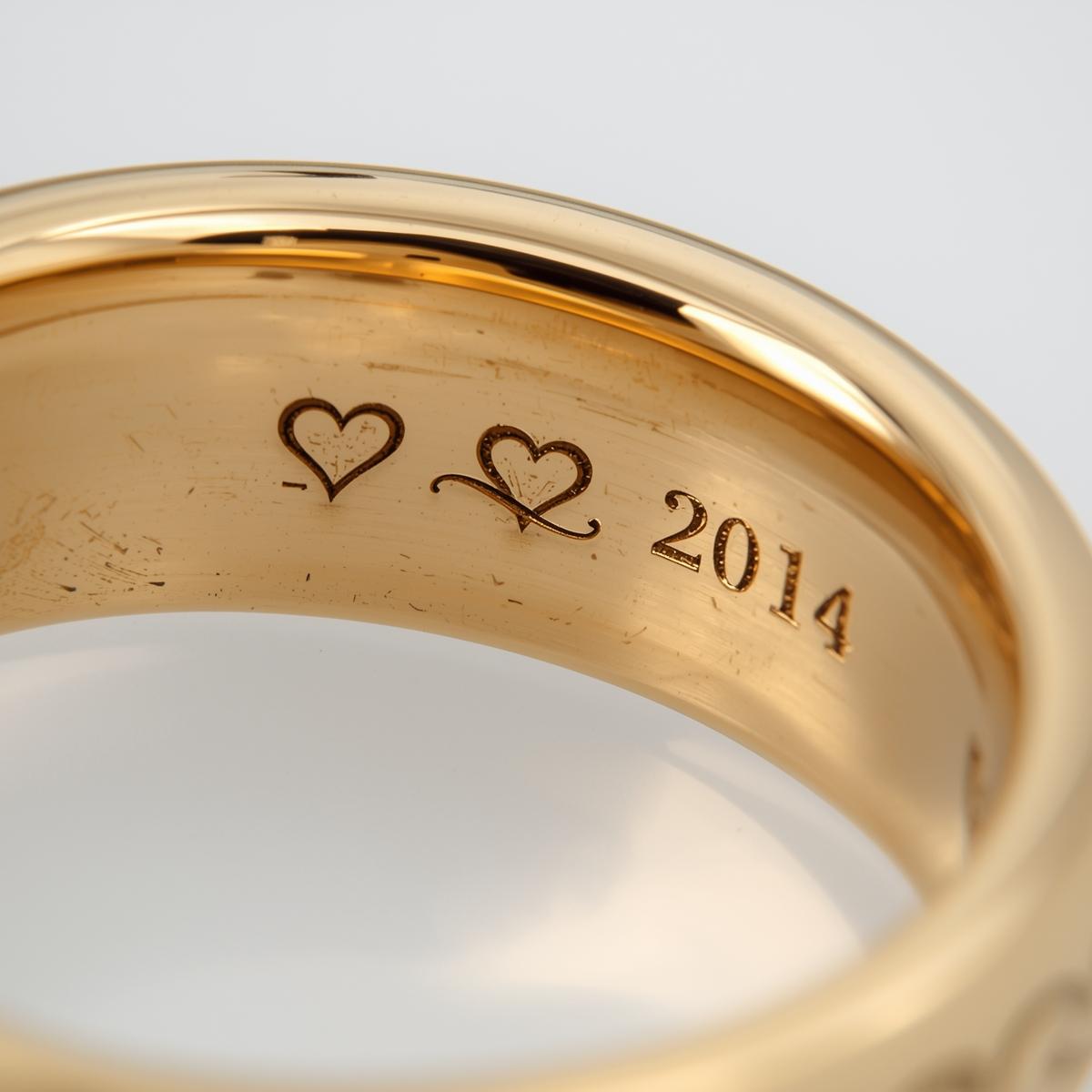 Gold ring with heart designs and the year 2014 engraved inside rings