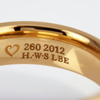Gold ring with engraved text inside rings