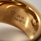 Gold ring with engraved heart and numbers on a white background